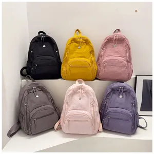 Multi-color casual backpack detail showcase, displaying fabric texture and zipper compartments.