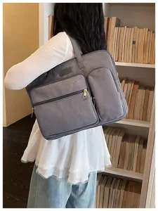 Dettaglio borsa portatile grigia multi-scomparto, grande capacità e stile da pendolare ideale.