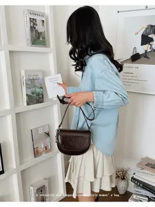 Vintage brown saddle bag for women, elegant shoulder crossbody bag with adjustable strap.