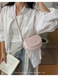 Stylish pink PU leather saddle shoulder bag with elegant metal chain strap and charm detail.