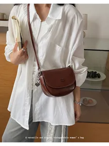 Vintage brown leather cross body saddle bag for women, elegant daily small shoulder bag.