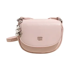 Pink saddle crossbody bag for women, cute heart charm shoulder bag, stylish mini purse.