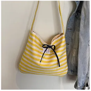 Yellow white striped canvas shoulder bag with cute bow and casual minimalist design for daily use.