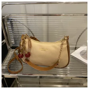 Casual crossbody fashion shoulder bag with cute cherry charms, trendy design for women.