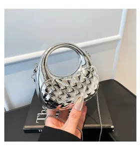 Silver metallic hard-shell handbag featuring circular top handle and stylish chain strap.