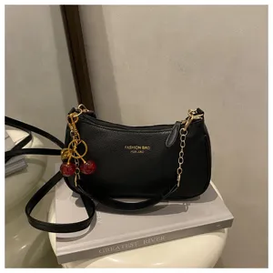 Black PU leather shoulder bag with chic cherry charm and gold chain, trendy casual crossbody design.