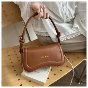 Stylish brown leather underarm shoulder bag for women, trendy curved design with knot handle.