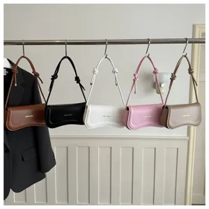 Minimalist leather underarm shoulder bag with knot strap detail, available in multiple colors.