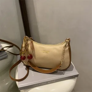 Trendy women's hobo shoulder bag with cherry charm, stylish beige casual crossbody bag for autumn.