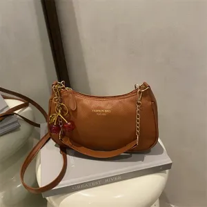 Brown shoulder bag for women, stylish PU leather crossbody bag with chain strap and cherry charm.