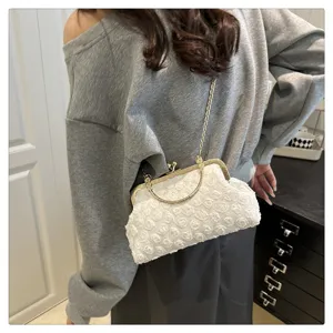 Elegant white floral textured mini clutch bag with gold chain strap for women evening party.