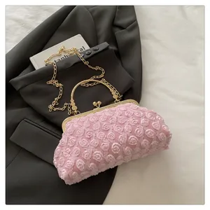 Exquisite pink rose lace evening bag detail, featuring gold metal frame and chain strap.