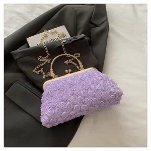 Elegant purple floral evening clutch bag with metal frame and gold chain strap for women.