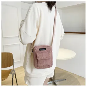 Pink corduroy cross-body mini bag detail, casual daily style, compact and stylish look.