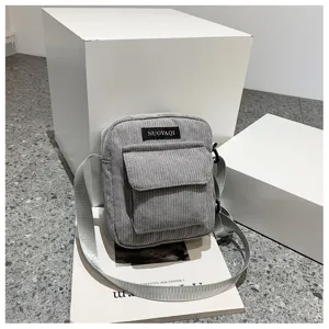 Grey corduroy crossbody bag detail, casual square shoulder bag with front pocket design.