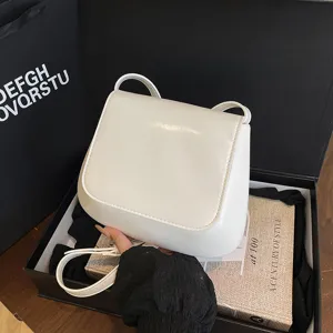 Chic white saddle bag for women, trendy cross-body PU leather shoulder bag for daily outfit.