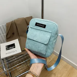 Trendy corduroy crossbody bag for women, light blue casual shoulder bag with front pocket.
