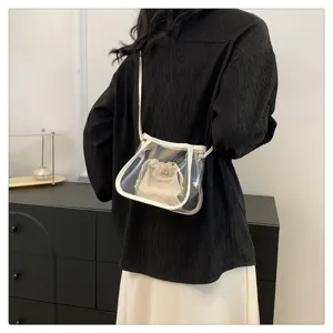 Transparent jelly crossbody bag detail showing clear PVC material and beige inner pouch.