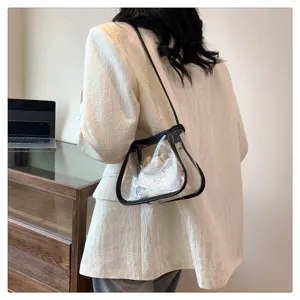 Detailed view of women transparent jelly shoulder bag with black trim and inner pouch.