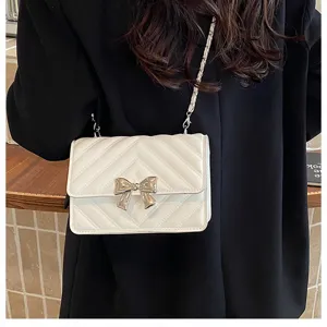 Chic women quilted chain crossbody bag with elegant metal bow detail for daily fashion.
