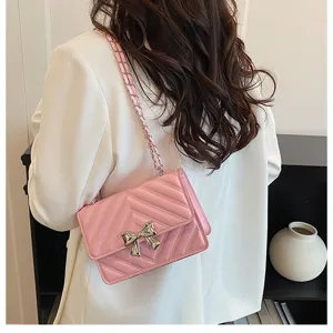 Pink quilted chain shoulder bag for women, elegant chevron crossbody bag with silver bow.