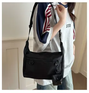 Japanese minimalist black messenger bag, versatile nylon crossbody bag for casual daily use.
