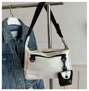 Minimalist white messenger bag for women, casual nylon crossbody bag with small pouch.