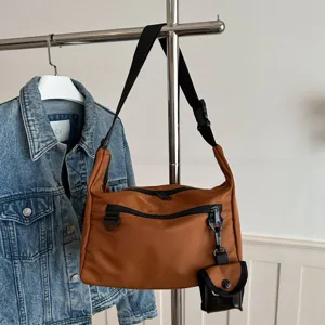 Casual nylon crossbody bag for women, stylish brown messenger bag with adjustable strap.