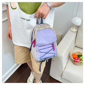 Casual stylish mini backpack in beige and purple with elastic cords, perfect for daily travel.