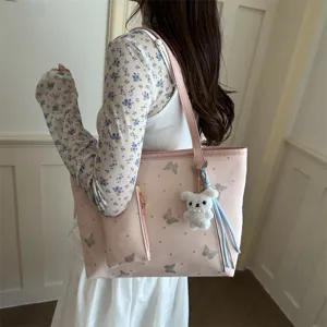 Trendy pink butterfly print tote bag for women, casual shoulder bag with cute bunny pendant.
