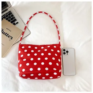 Red white polka dot nylon shoulder bag detail, stylish underarm tote handbag for women commuting.