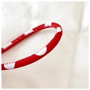 Detailed view of the red nylon strap with white polka dots for stylish shoulder bag