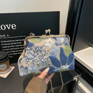 Exquisite detail view of the new Chinese style embroidered sequin handbag with kiss-lock clasp.