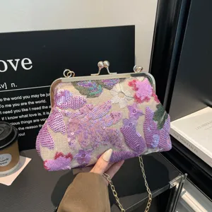 Exquisite floral sequin embroidered clutch bag with metal kiss-lock frame and chain strap.