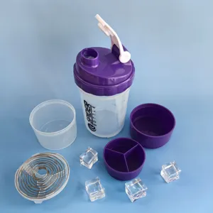 Detailed view of clear protein shaker bottle with purple compartments and storage box accessories.