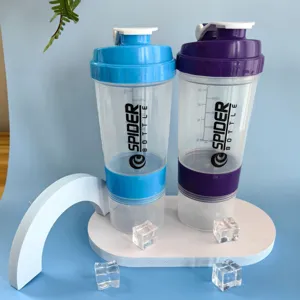 Detailed view of plastic protein powder shaker bottle with compartment and scale marks.
