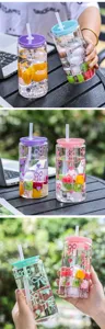 Clear glass tumbler with straw and lid, cute bow pattern, perfect for iced coffee and juice.