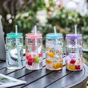 Colorful glass straw cup with cute bow patterns, portable and heat resistant for office use.