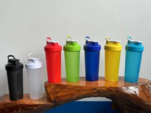Colorful plastic shaker bottles displayed on wooden stand for sports fitness detail.