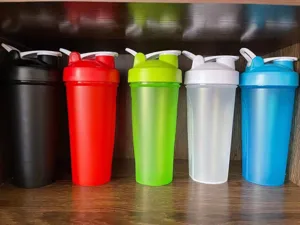 Detailed view of colorful fitness shaker bottles for protein powder, portable and leak-proof.