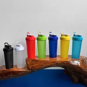 Multicolor fitness shaker bottle with portable handle, ideal for protein shakes and sports.