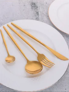 Gold stainless steel cutlery set detail, elegant knife fork and spoon for modern dining.