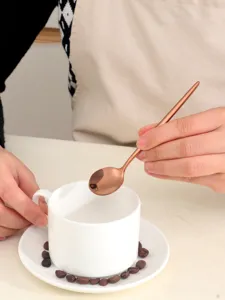 Exquisite stainless steel coffee spoon detail, elegant rose gold flatware for modern dining.