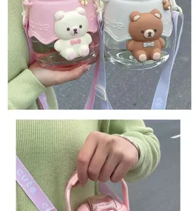Detail view of large capacity straw water bottle with cute 3D cartoon bear sleeve and strap.