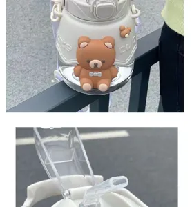 Close-up view of the cute large capacity water bottle with 3D bear decoration and straw detail.