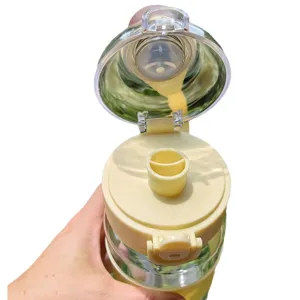 Large capacity plastic sports water bottle with open straw lid and portable modern design.