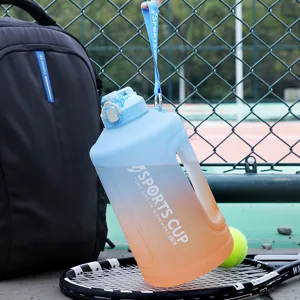Large capacity gradient sports water bottle with straw and portable strap for outdoor use.