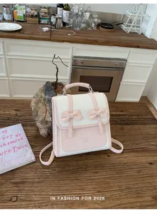 Vista dettagliata del grazioso zaino rosa e bianco con doppi fiocchi carini per uso quotidiano.