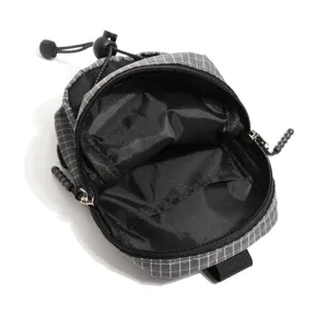Detailed view of the tactical grid shoulder pouch showing open interior zipper and mesh pocket.