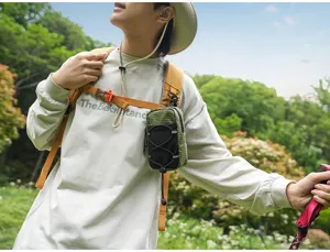 Detail shot of an outdoor tactical shoulder strap storage pouch for hiking gear and travel.